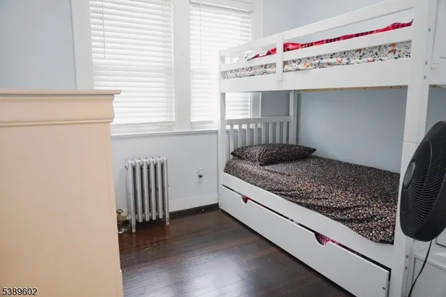 a living room with a bed and a window