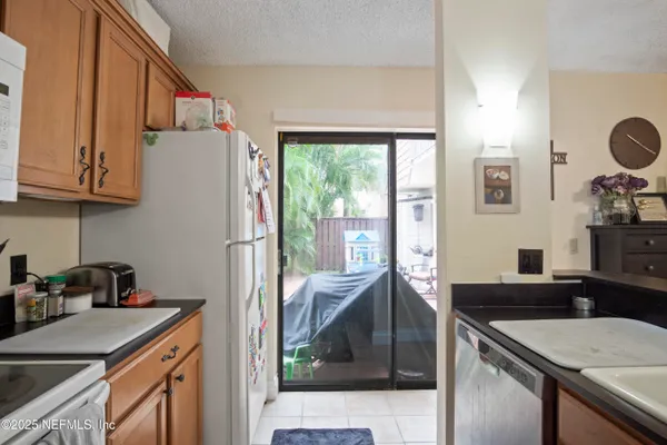 a kitchen with a sink a stove and a refrigerator