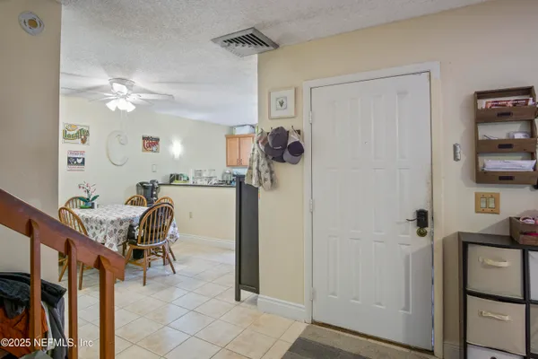 a dining room with furniture and chandelier fan