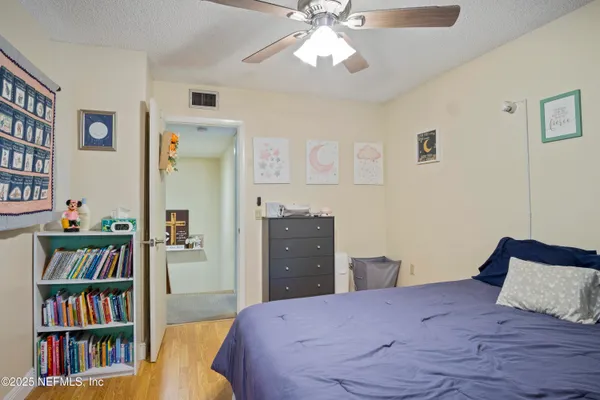 a bedroom with a bed and a book shelf