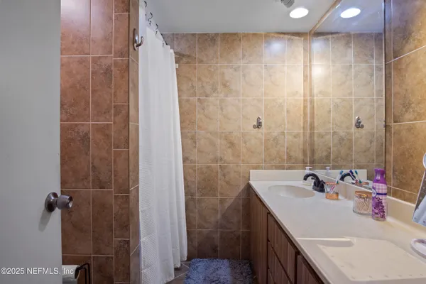 a bathroom with a sink double vanity and shower
