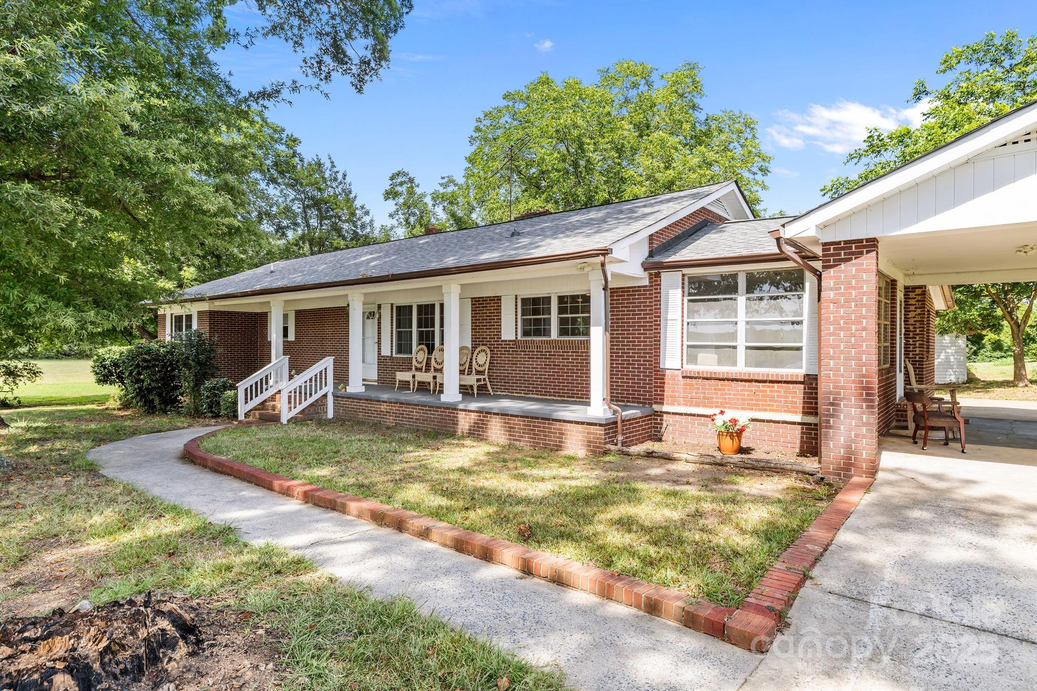 3825 Stack Road Monroe, NC 28112 - Photo 12 of 20 a view of a yard in front of a house with a large tree