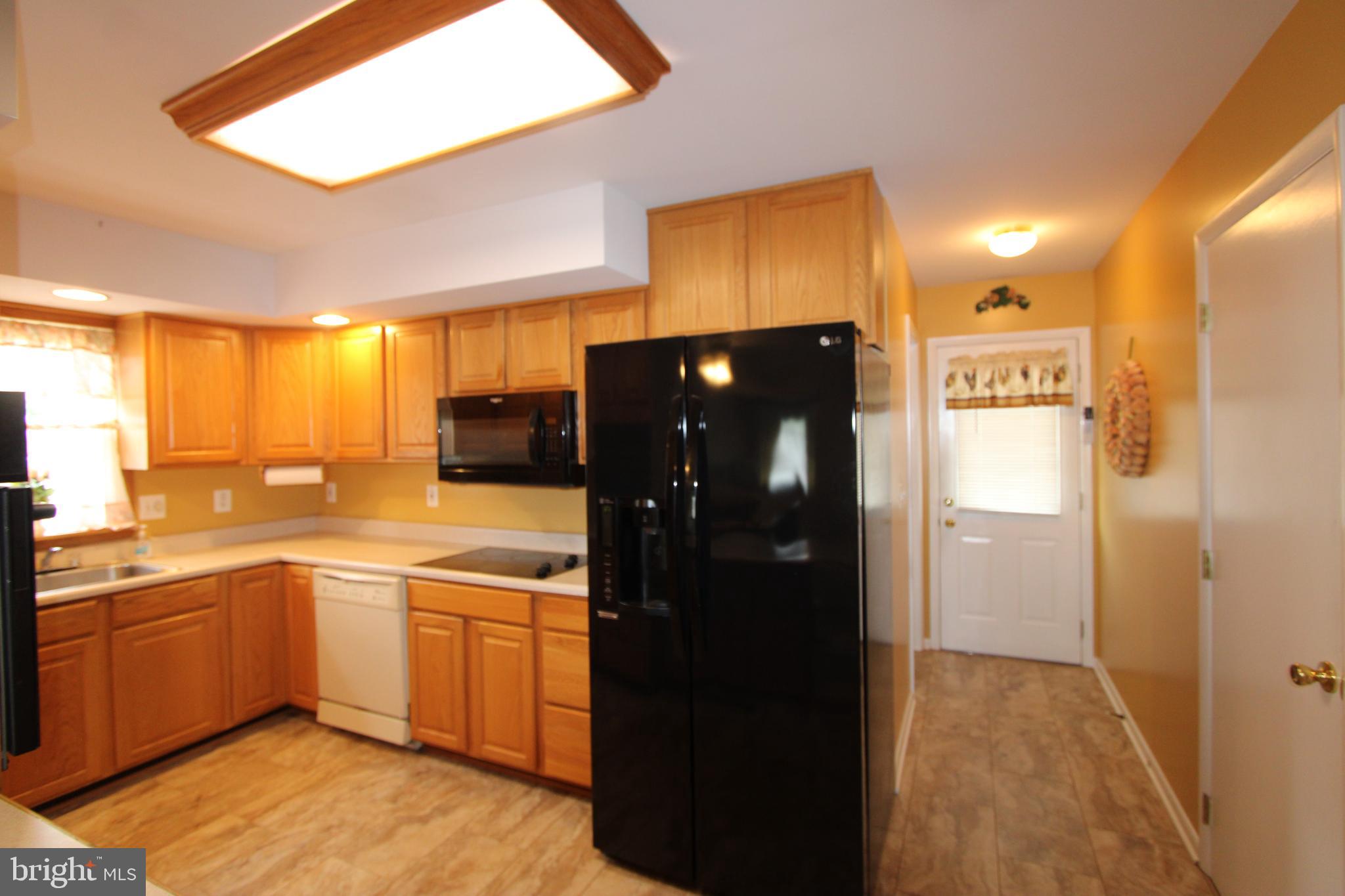 1604 Cape May Road Baltimore, MD 21221 - Photo 3 of 30 a kitchen with a refrigerator and a sink