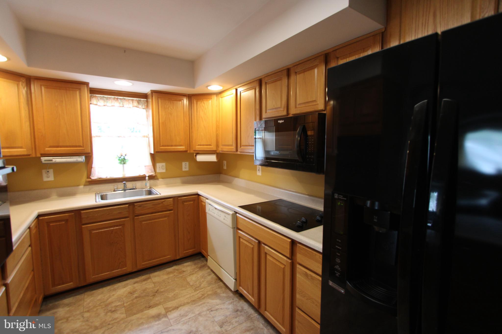 1604 Cape May Road Baltimore, MD 21221 - Photo 7 of 30 a kitchen with stainless steel appliances granite countertop a sink stove and refrigerator