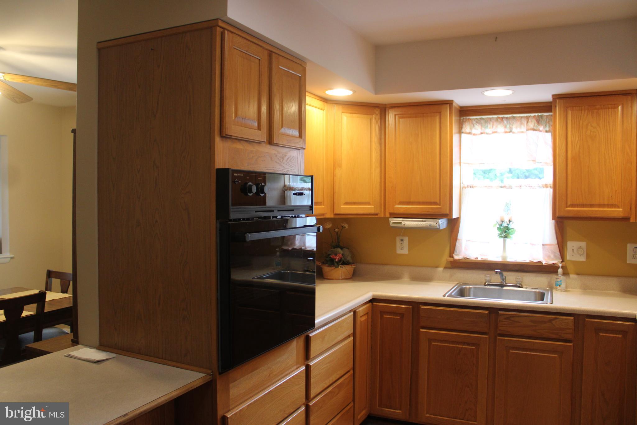 1604 Cape May Road Baltimore, MD 21221 - Photo 8 of 30 a kitchen with a sink a refrigerator and cabinets