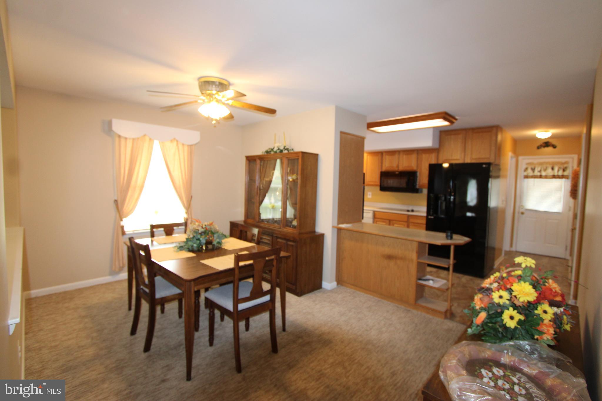 1604 Cape May Road Baltimore, MD 21221 - Photo 10 of 30 a dining room with furniture a chandelier and kitchen view