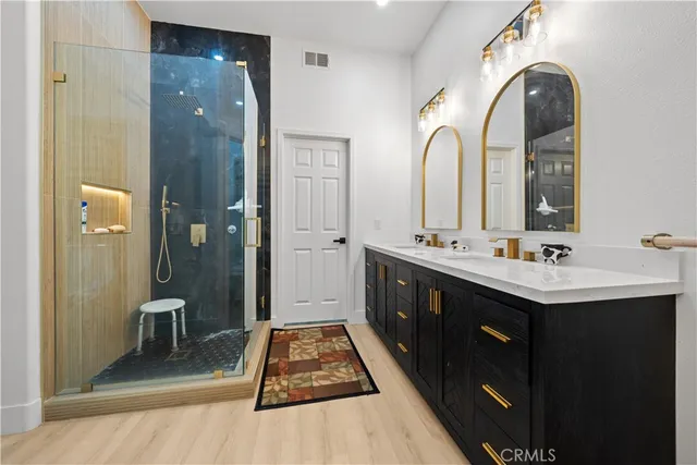 a spacious bathroom with a double vanity sink and a mirror