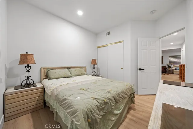 a bedroom with a bed and a mirror