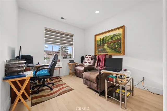 a living room with furniture a air conditioner and a window