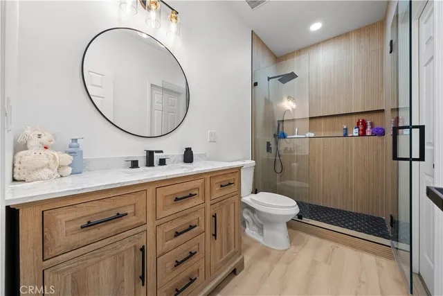 a bathroom with a toilet a sink and a mirror