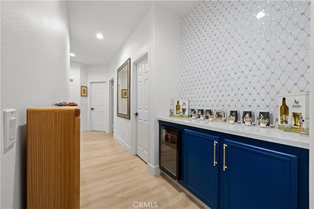 a kitchen with refrigerator and cabinets