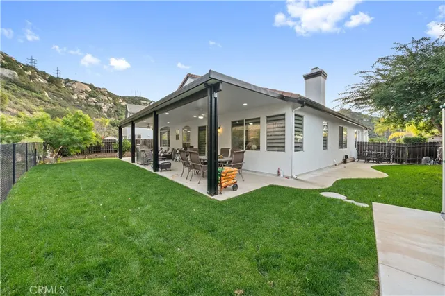 a view of a house with a yard and sitting area