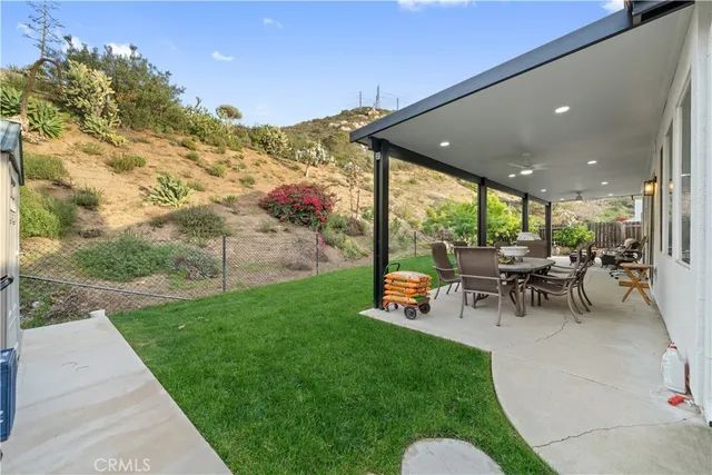 a view of a porch with chairs and backyard