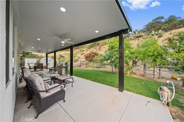 a building outdoor space with patio furniture and garden