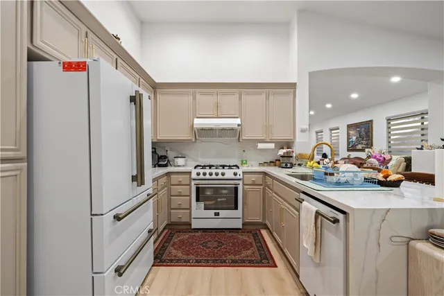 a kitchen with white cabinets and white appliances