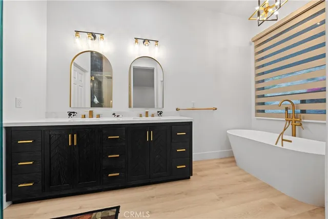 a bathroom with a double vanity sink and a mirror