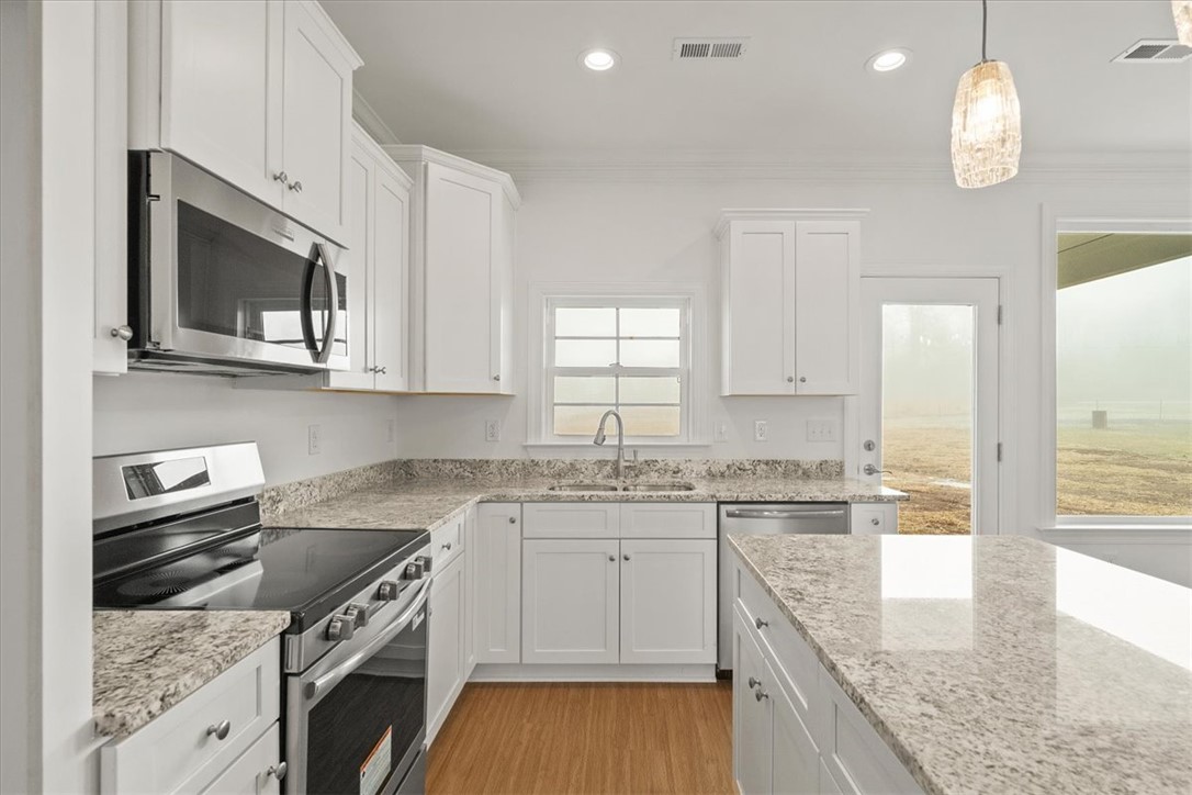 108 Oak Grove Road Norris, SC 29667 - Photo 12 of 35 This bright kitchen features ample counter space, modern appliances, and a seamless connection to the outdoors.