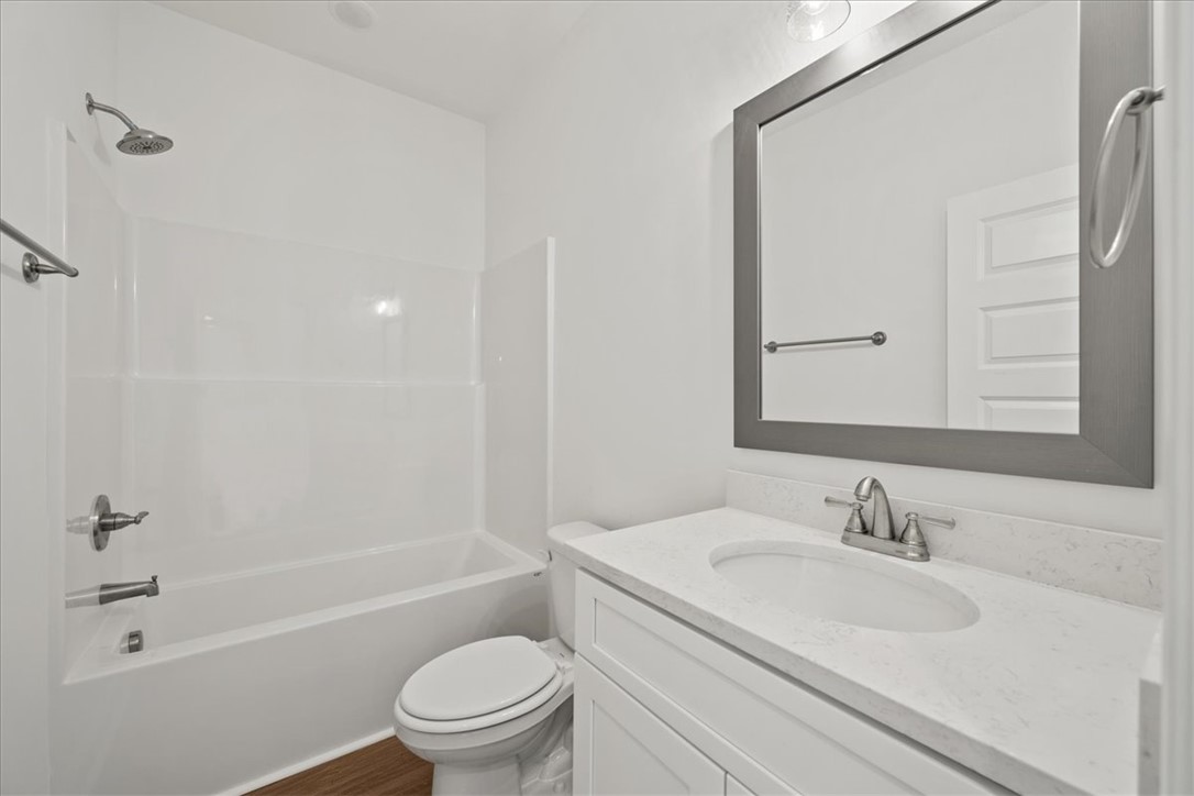 108 Oak Grove Road Norris, SC 29667 - Photo 17 of 35 This bright bathroom features a spacious tub and shower combination with a sleek vanity and mirror.