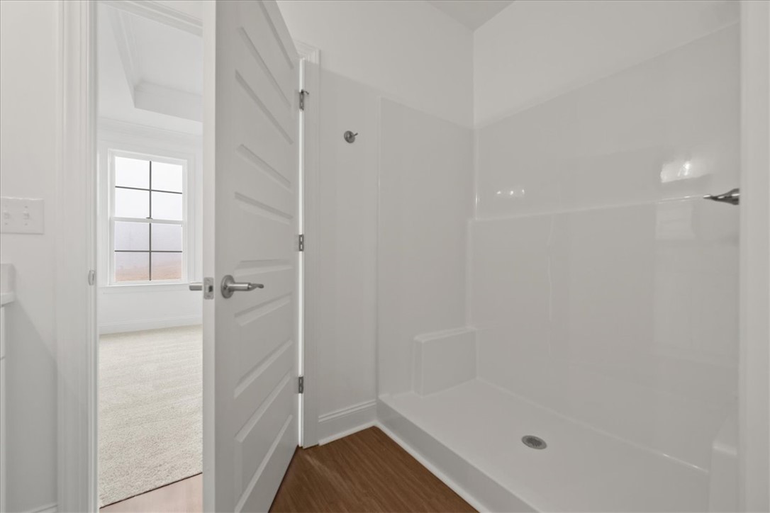 108 Oak Grove Road Norris, SC 29667 - Photo 30 of 35 This bright bathroom features a spacious shower with simple, clean design and modern flooring.