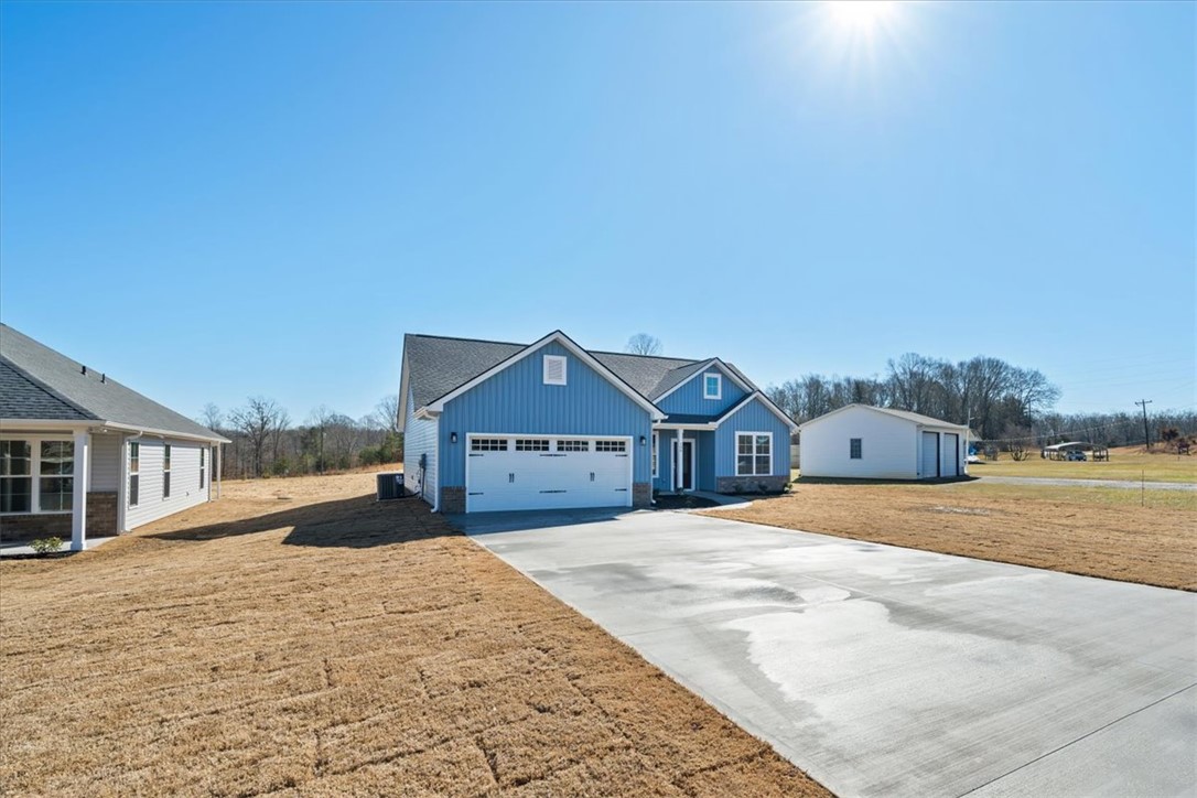 108 Oak Grove Road Norris, SC 29667 - Photo 3 of 35 This charming residence showcases a classic design with an attached garage and a detached outbuilding.