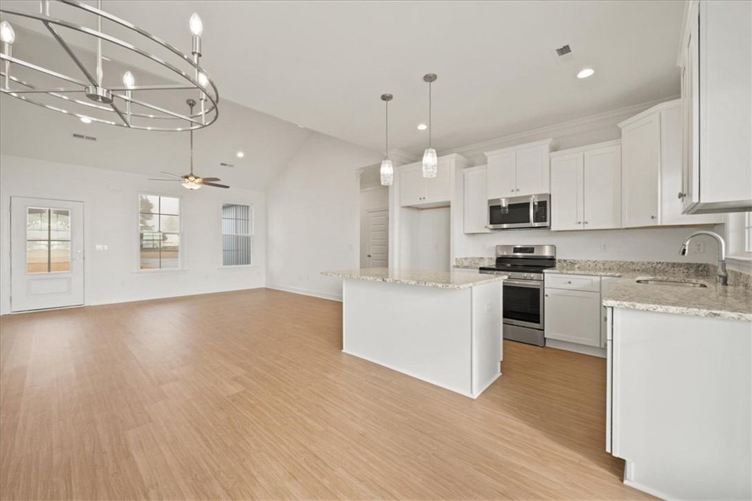 108 Oak Grove Road Norris, SC 29667 - Photo 9 of 35 This airy open-concept space features a well-appointed kitchen and spacious living area with vaulted ceilings.