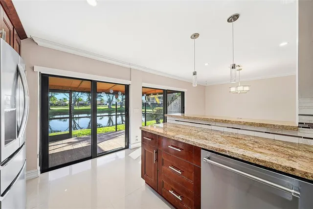 a open kitchen with granite countertop a sink and a window