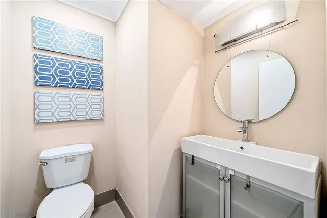a bathroom with a toilet a sink and a mirror