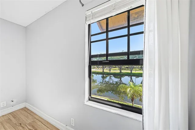 an empty room with wooden floor and doors