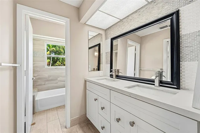 a bathroom with a double vanity sink and a mirror