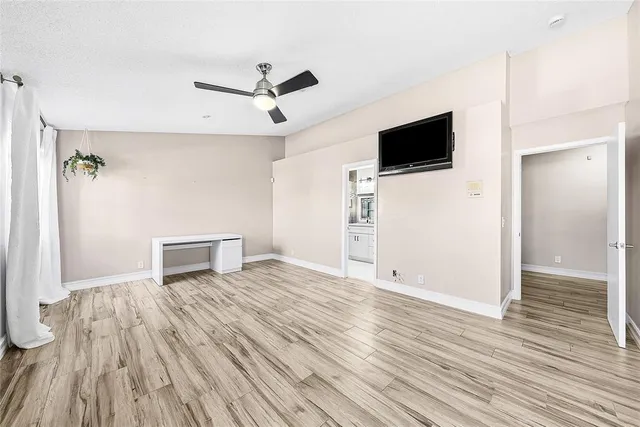 a view of livingroom with hardwood floor and a ceiling fan