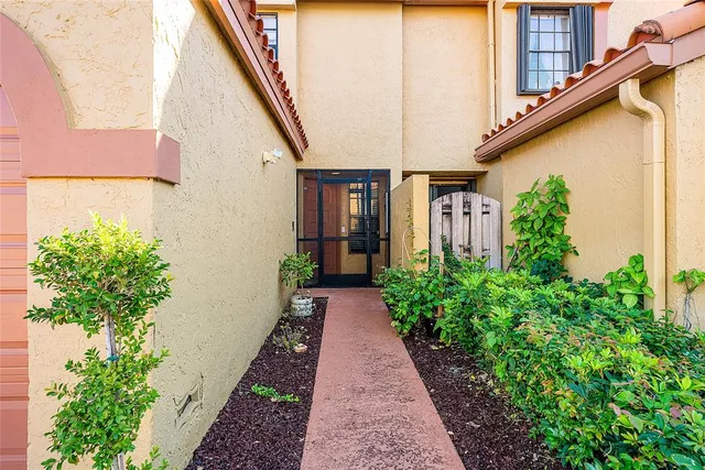 a house with potted plants in front of it