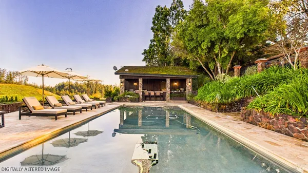 swimming pool view with a seating space