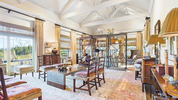 a living room with furniture a rug and a large window