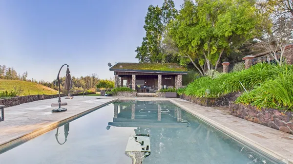 swimming pool view with a seating space