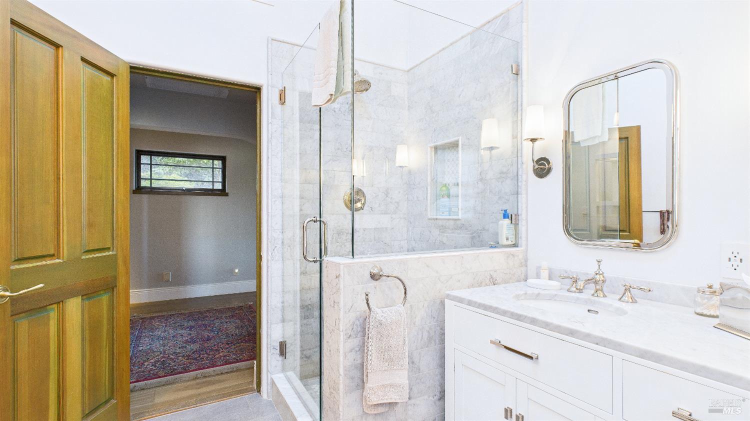 3225 West Dry Creek Road Healdsburg, CA 95448 - Photo 23 of 45 a bathroom with a granite countertop sink a mirror and a shower