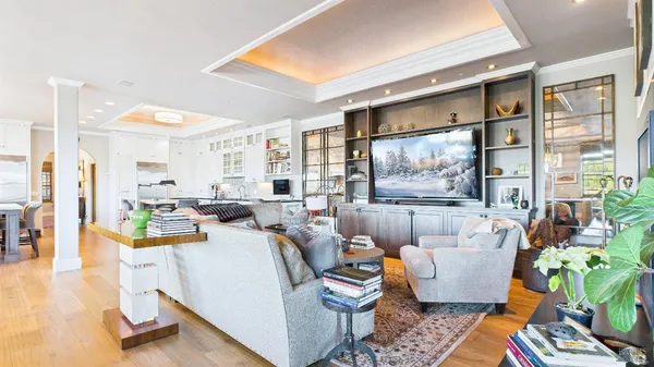 a living room with stainless steel appliances granite countertop furniture and a kitchen
