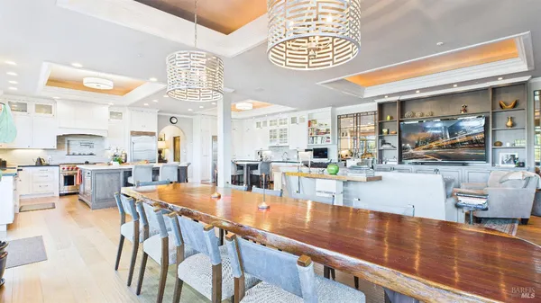 a large kitchen with a table and chairs