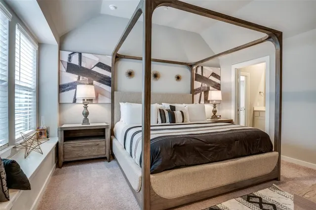 a view of a bedroom with a bed and a window