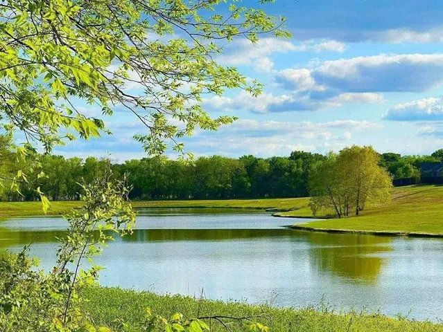 a view of an ocean with a table and chair
