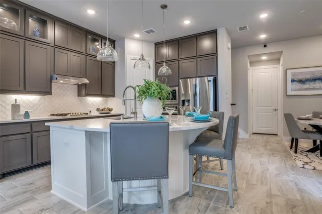 a kitchen with counter space dining table and chairs