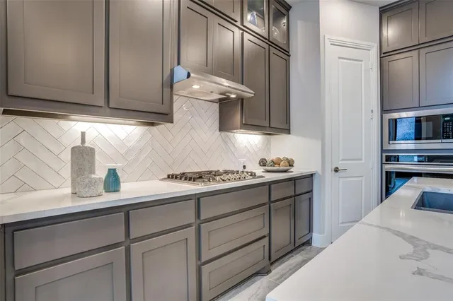 a kitchen with cabinets appliances and a sink