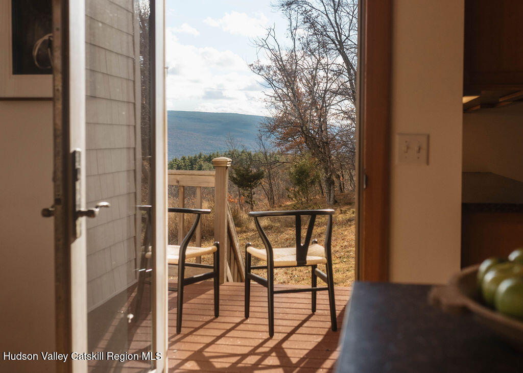 56 Woodland Ridge Road Kerhonkson, NY 12446 - Photo 18 of 31 a balcony with table and chairs