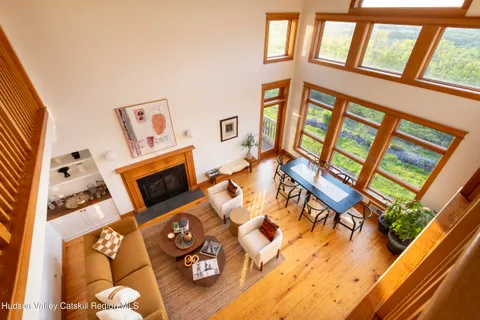 a view of a refrigerator a chair and wooden floor