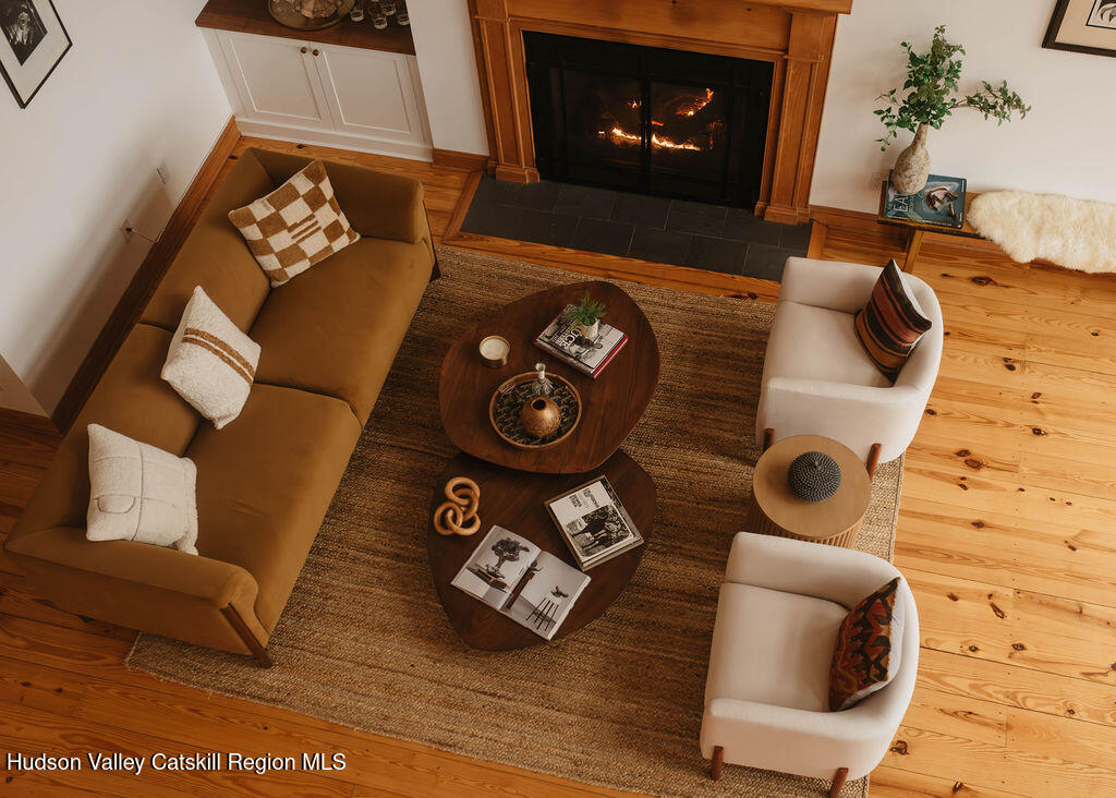 56 Woodland Ridge Road Kerhonkson, NY 12446 - Photo 2 of 7 a living room with furniture and a fireplace