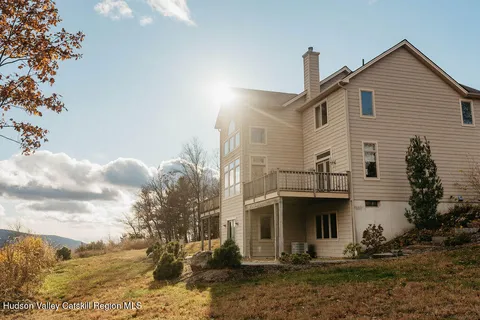 a view of a white house with large windows