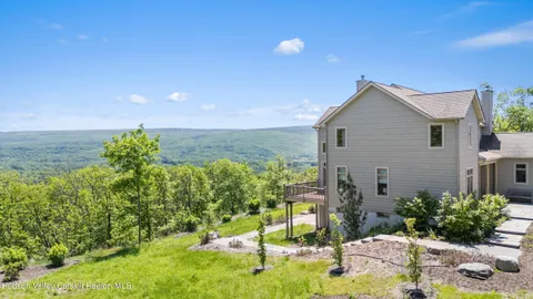 a view of a house with a backyard and a garden
