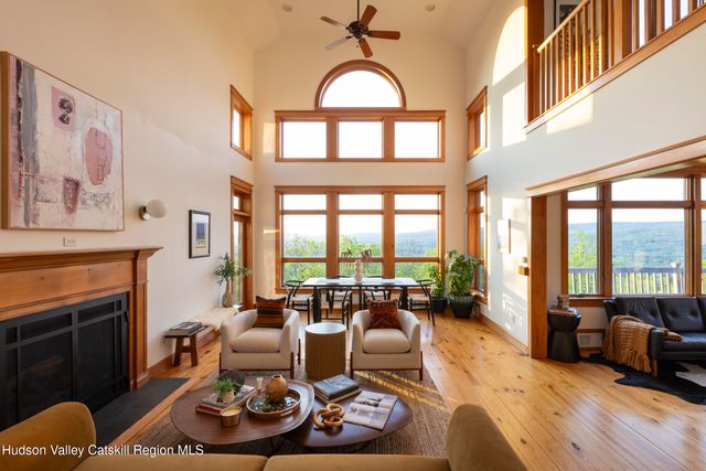 a living room with furniture fireplace and a large window