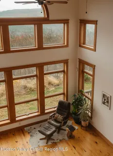a room with furniture and two windows