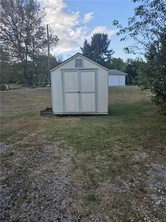 a view of a barn in the middle of a yard