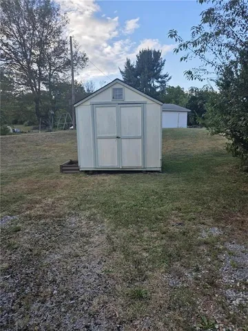 a view of a barn in the middle of a yard